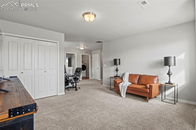 carpeted office space featuring washer / clothes dryer, visible vents, and baseboards