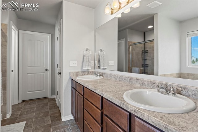 full bath featuring double vanity, a stall shower, a sink, and visible vents