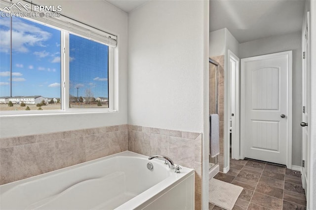 bathroom with a garden tub and a shower stall