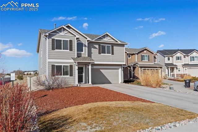 view of front facade featuring a garage, a residential view, concrete driveway, and fence