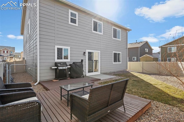 rear view of property with a residential view, a fenced backyard, a yard, and a deck