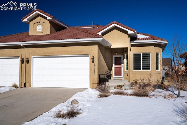 view of front facade featuring a garage, a tile roof, concrete driveway, and stucco siding