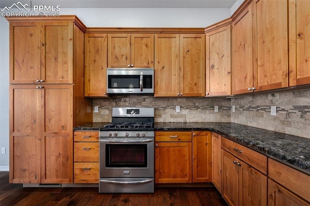 kitchen featuring brown cabinets, dark wood-style floors, and stainless steel appliances