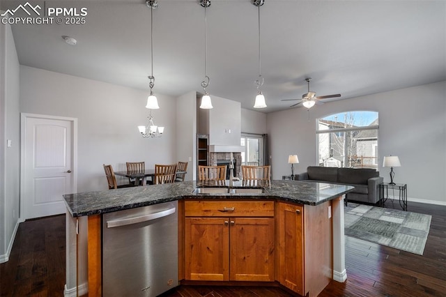 kitchen with dark wood-type flooring, open floor plan, dishwasher, and an island with sink