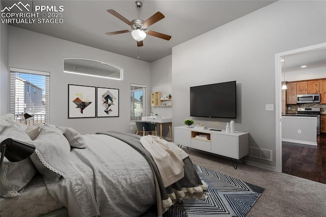 bedroom with dark colored carpet, visible vents, ceiling fan, and baseboards