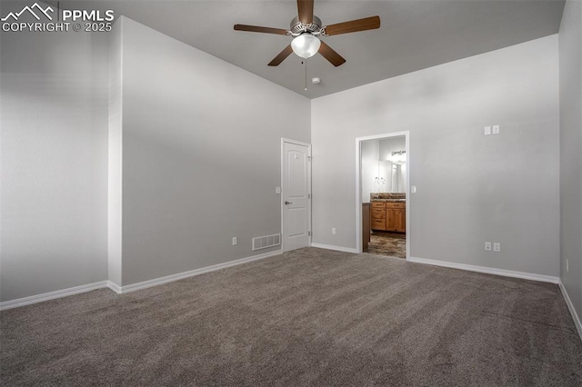 unfurnished bedroom featuring visible vents, baseboards, a ceiling fan, connected bathroom, and carpet