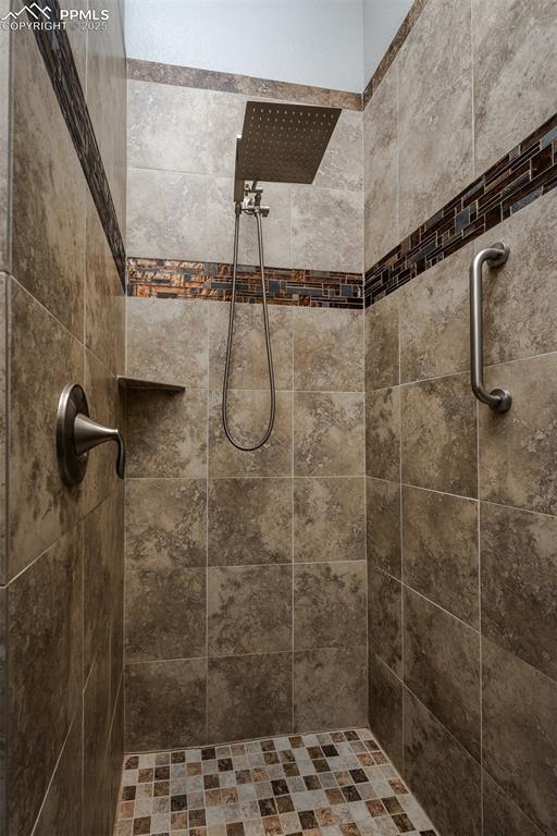 bathroom with tiled shower