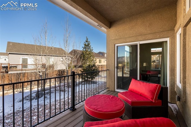 snow covered back of property featuring a residential view