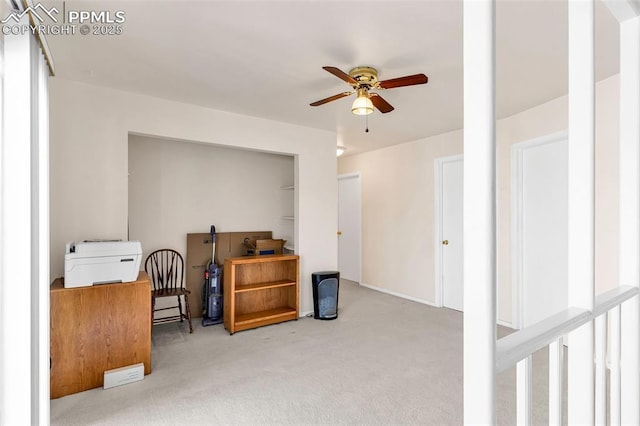 interior space with a ceiling fan and light colored carpet