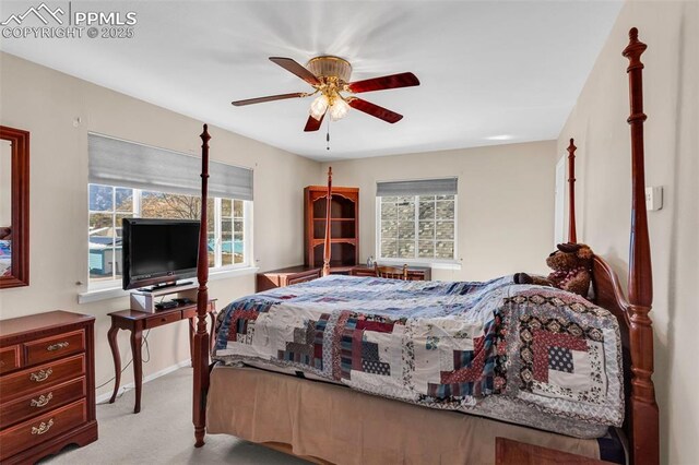 bedroom featuring baseboards, multiple windows, a ceiling fan, and carpet flooring