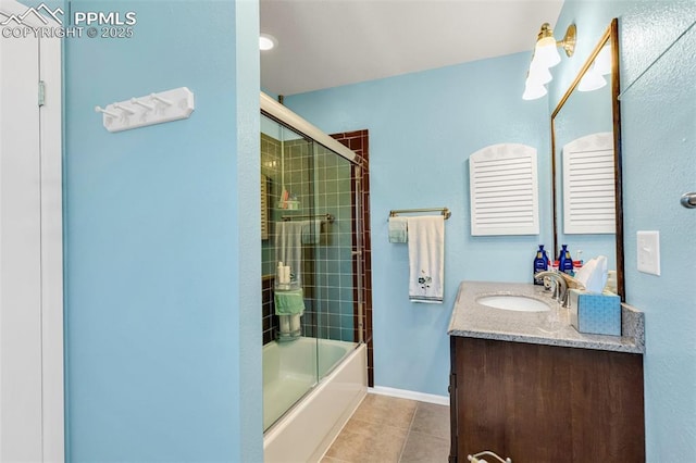 full bath with tile patterned flooring, bath / shower combo with glass door, baseboards, and vanity