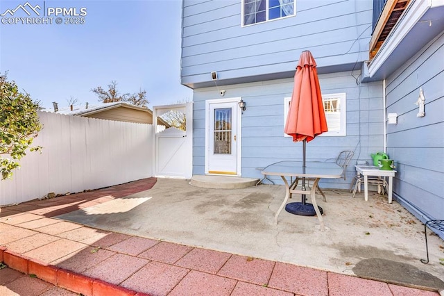 entrance to property with a patio and fence