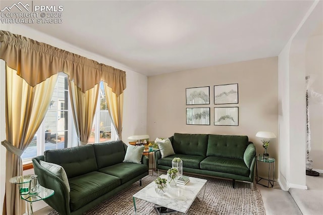 living room with plenty of natural light and baseboards