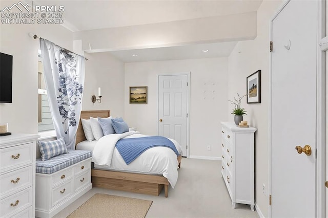 bedroom featuring baseboards and light colored carpet