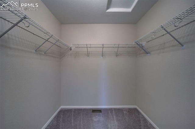 walk in closet with carpet floors and visible vents