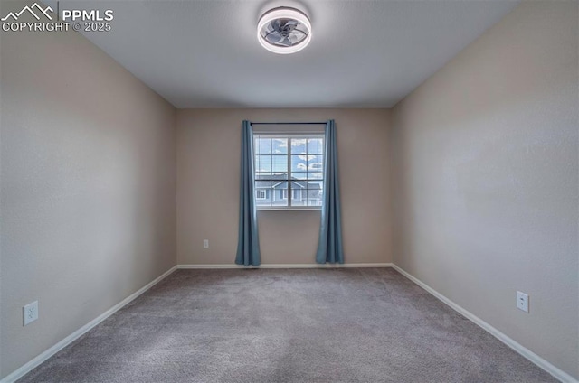 carpeted empty room featuring baseboards