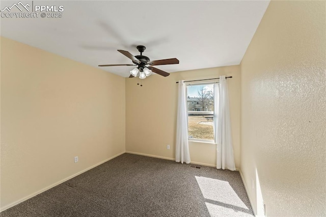 carpeted spare room with ceiling fan, visible vents, and baseboards