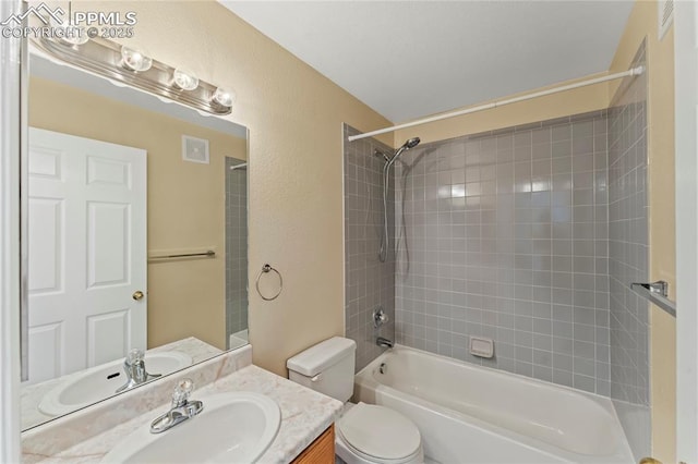 full bath featuring a textured wall, toilet, vanity, visible vents, and tub / shower combination