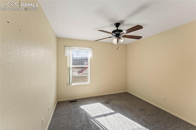 carpeted spare room featuring ceiling fan, visible vents, and baseboards