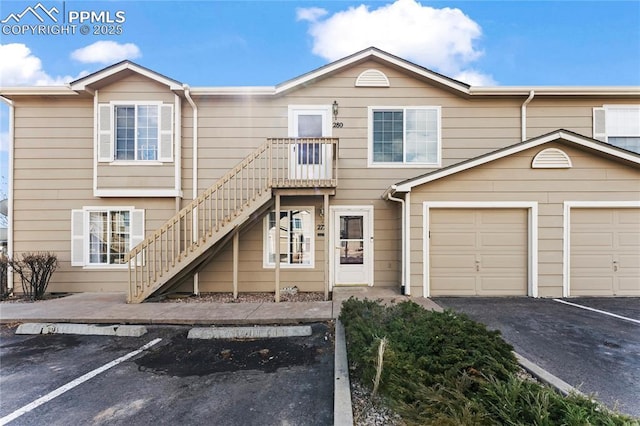 townhome / multi-family property featuring a garage and stairway