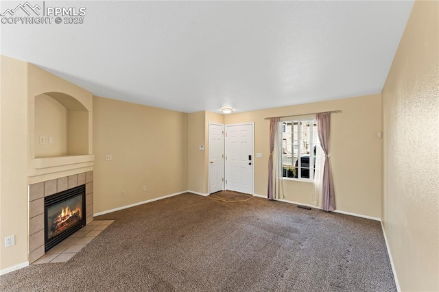 unfurnished living room featuring carpet, a fireplace, and baseboards