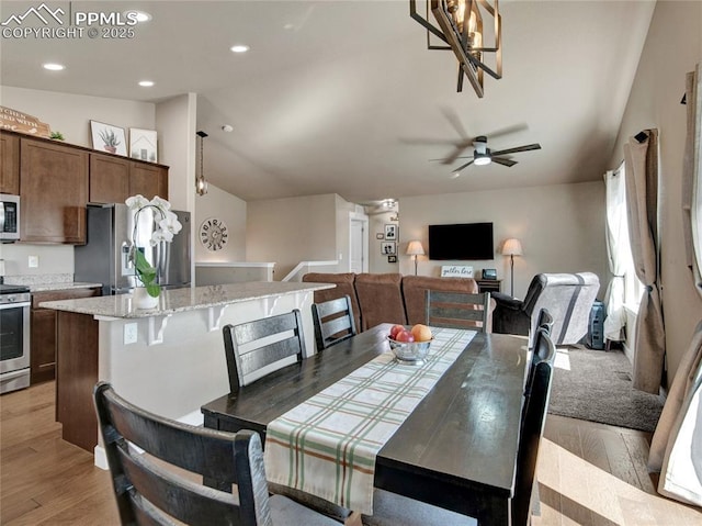 dining area featuring lofted ceiling, light wood-style floors, ceiling fan, and recessed lighting