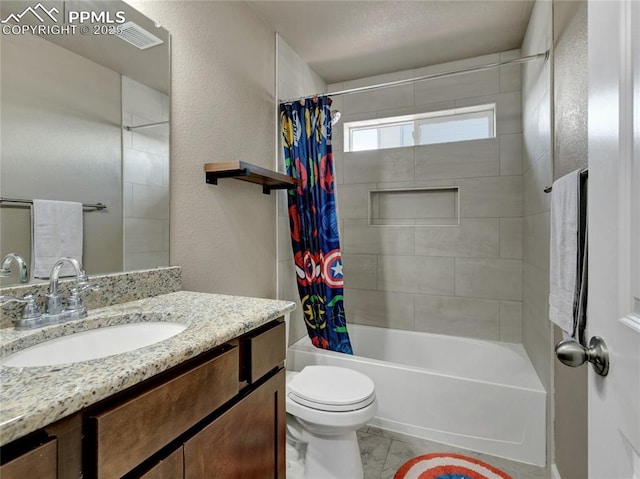 full bath with a textured wall, shower / bath combo, vanity, and toilet