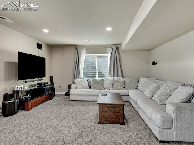 carpeted living area featuring baseboards, visible vents, and recessed lighting