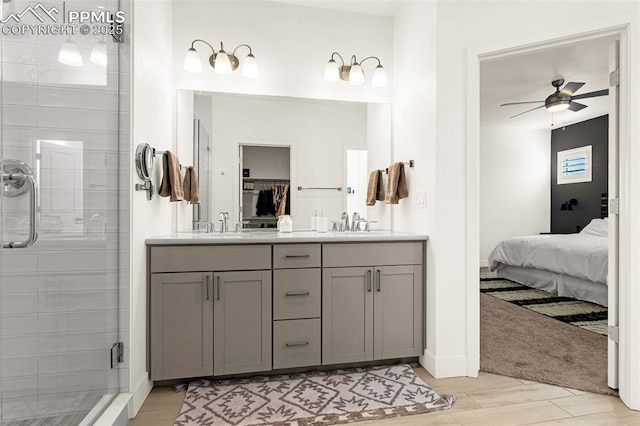 ensuite bathroom featuring a shower stall, connected bathroom, double vanity, a ceiling fan, and a sink