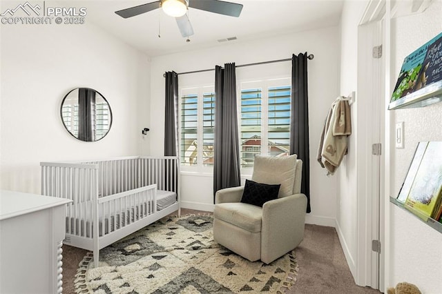 bedroom with visible vents, baseboards, a nursery area, and carpet