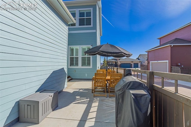 view of patio with area for grilling and fence