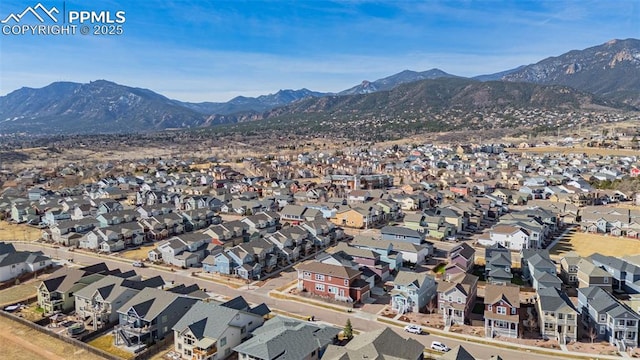 birds eye view of property with a mountain view and a residential view