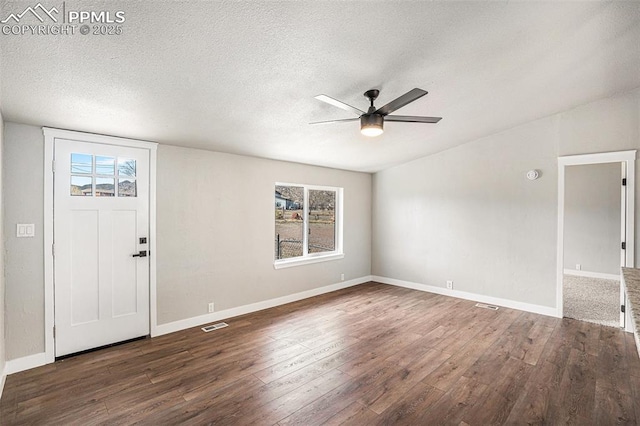 interior space featuring baseboards, a textured ceiling, a ceiling fan, and wood finished floors