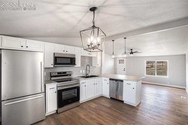 kitchen featuring appliances with stainless steel finishes, dark wood-type flooring, a sink, and white cabinetry