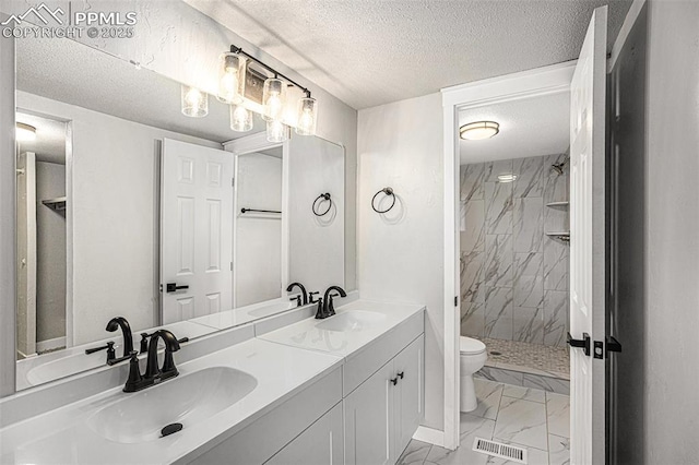 full bath with marble finish floor, visible vents, and a sink