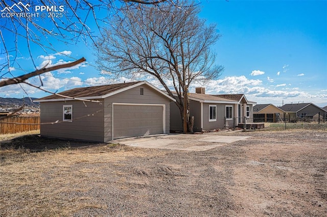 exterior space featuring a garage and fence