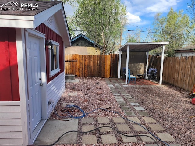 view of yard with an outbuilding, a patio area, and a fenced backyard