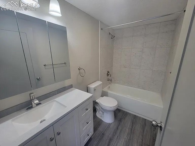 full bathroom with shower / washtub combination, vanity, toilet, and wood finished floors