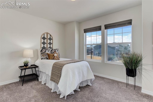 carpeted bedroom with baseboards