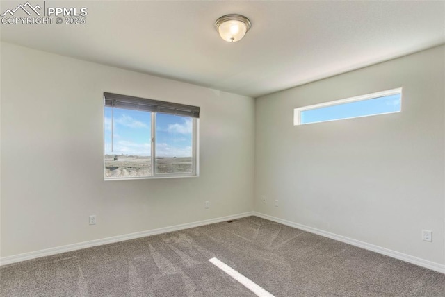 empty room with carpet and baseboards