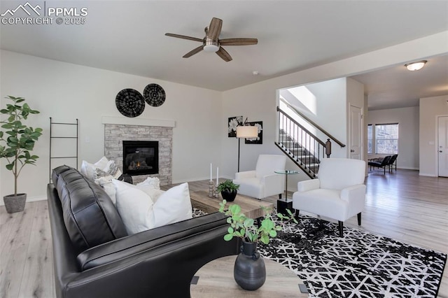 living area featuring stairway, wood finished floors, and baseboards