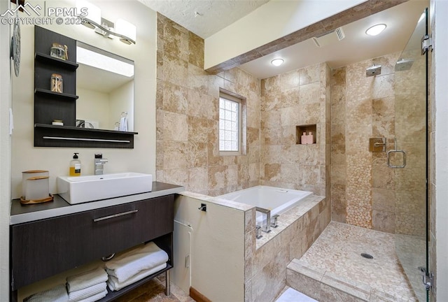 bathroom featuring a stall shower, a relaxing tiled tub, vanity, and visible vents