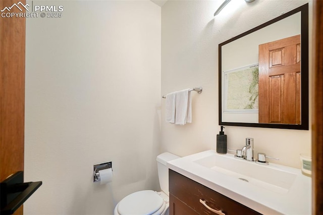 bathroom with toilet and vanity