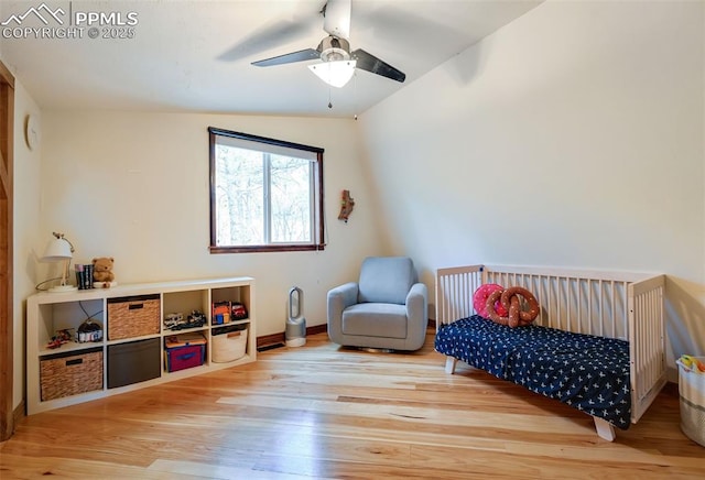 bedroom featuring ceiling fan, baseboards, and wood finished floors