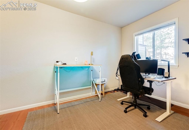 office space featuring baseboards and wood finished floors