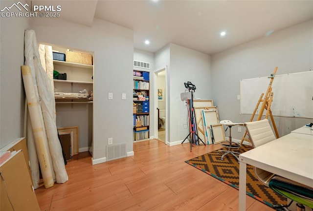 office featuring recessed lighting, visible vents, light wood-style flooring, and baseboards