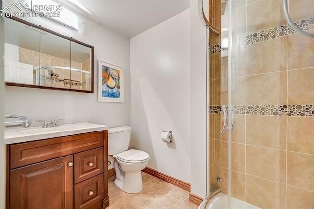 bathroom with baseboards, vanity, toilet, and tile patterned floors