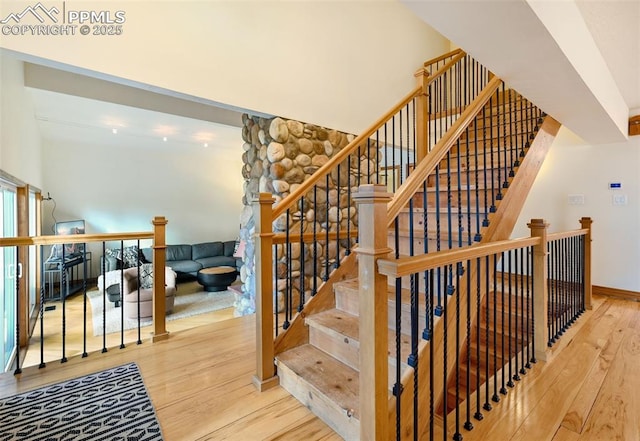 stairs featuring baseboards and wood finished floors