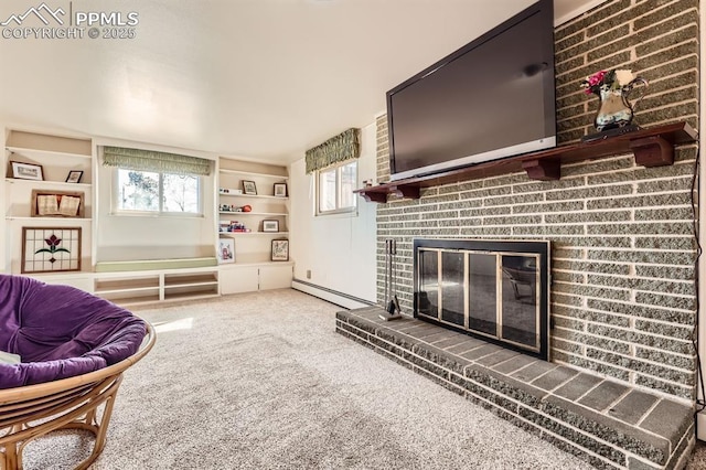 living area with carpet flooring, a fireplace, built in shelves, and a baseboard radiator