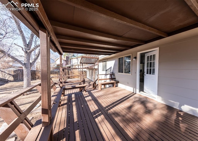 wooden terrace featuring fence